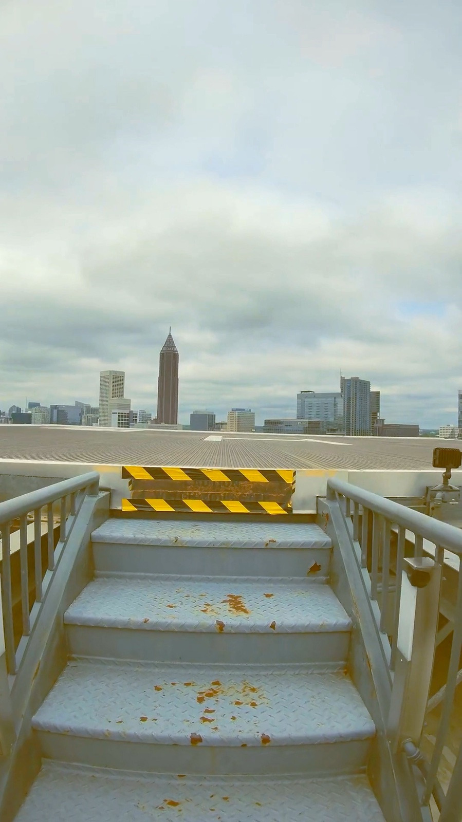 Real steps up to the 16F private rooftop helipad at Ventanas &middot; Atlanta skyline &middot; VIP-only